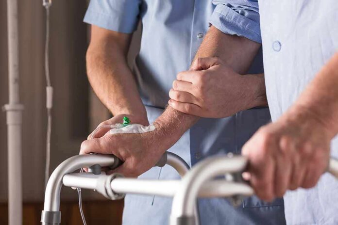 Elderly person using a walker with caregiver support