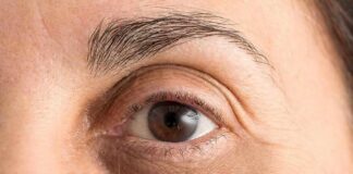 Close-up of a human eye with visible wrinkles and eyebrow