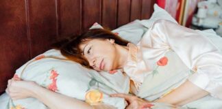 woman lying in bed looking pensive