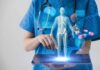 Mount Sinai’s Bold Bet: Digital Twin Tracks You Healthcare professional uses tablet with medical holograms